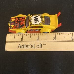 2011 HOT WHEELS ART CARS MAD MANGA YELLOW RED & BLUE 1:64 DIECAST 3 1/4" CAR